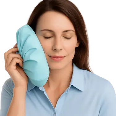 Mujer aplicando frío en la mejilla durante el postoperatorio de implantes dentales en Madrid