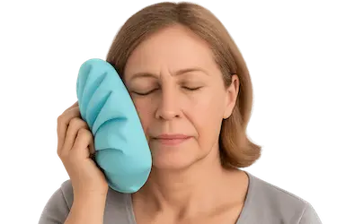 Paciente aplicando frío local en la mejilla tras expansión ósea dental en Madrid